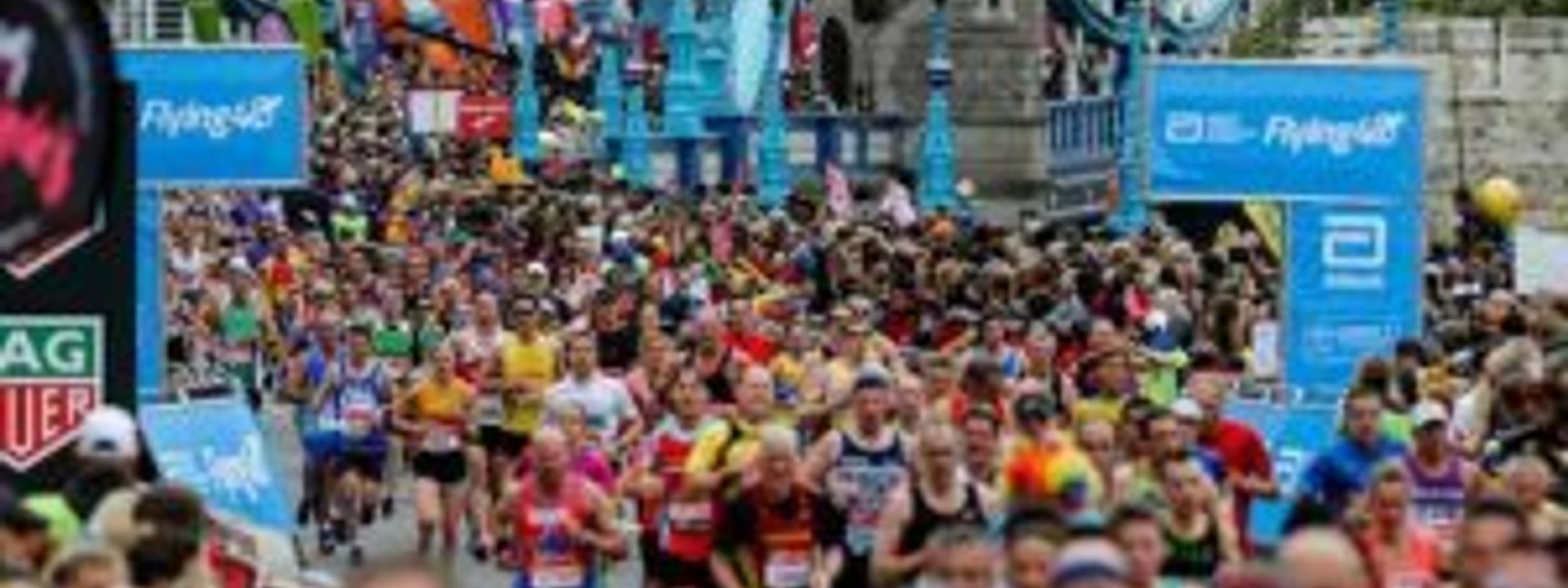 Dozens of people running with the headline "London Marathon 2020".