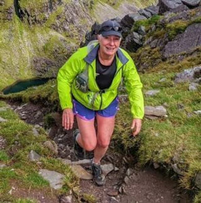 A woman hiking in the mountains.