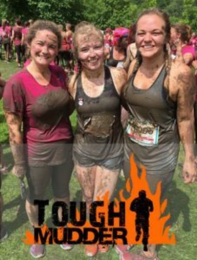 A group of three women with the Tough Mudder logo overlaid.