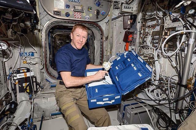 Tim Peake unpacking the CCFP on board the International Space Station.