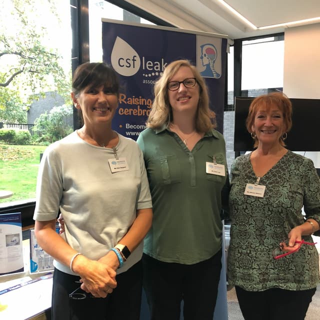 Trustees Clare Sargeant and Clare Joy, and Michele Welborn in front of a CSF Leak Association booth at an event.