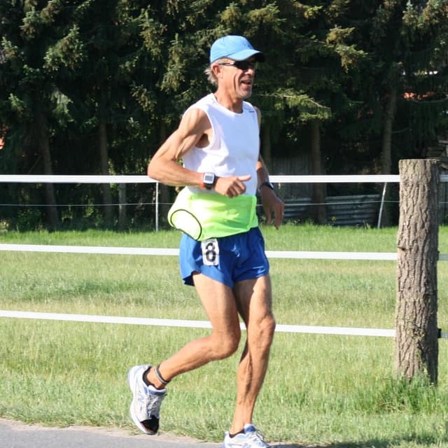 A man running in a race outside.