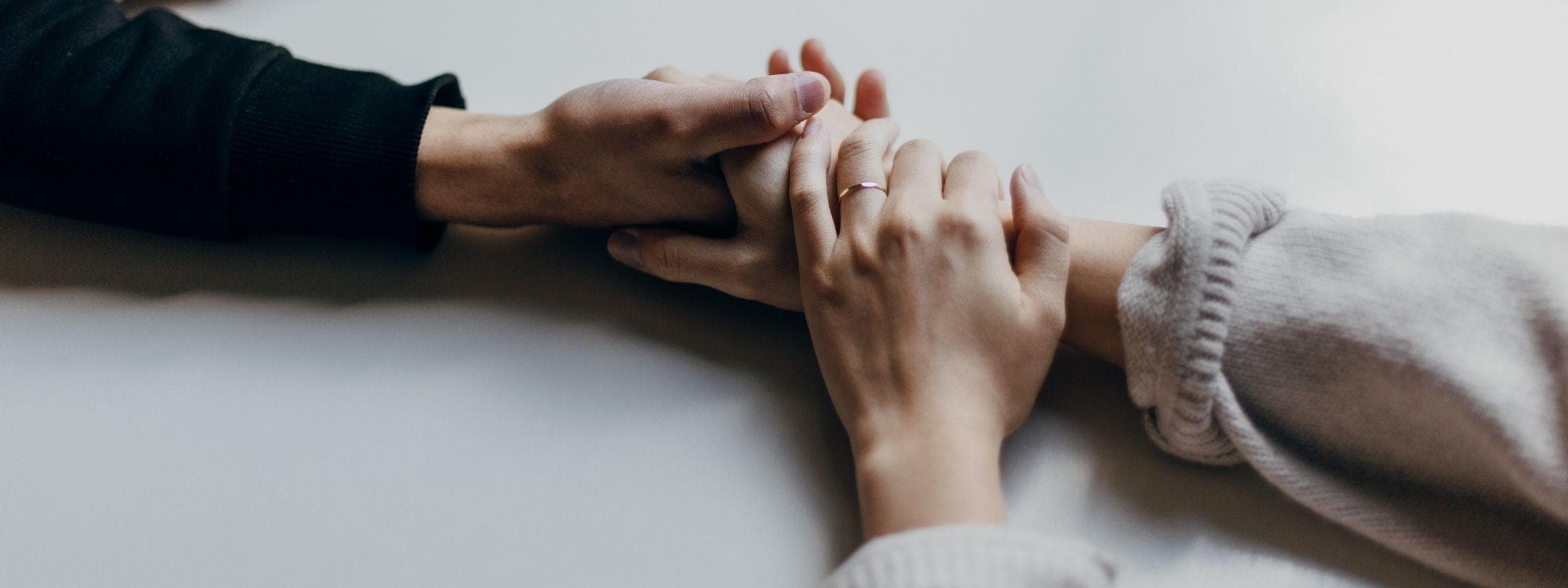 Two hands holding each other.