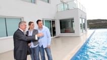 Couple visiting luxury villa with real estate agent