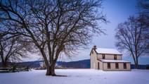 Small house and trees in a snow covered field in Gettysburg Pennsylvania