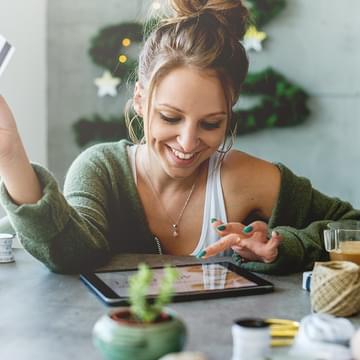 woman online shopping and smiling card in air
