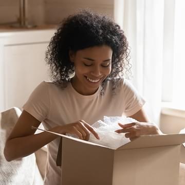 woman opening a box and smiling
