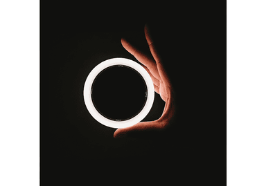 Hand holding a ring of light