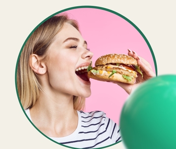 Woman biting into a burger