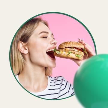 Woman biting into a burger