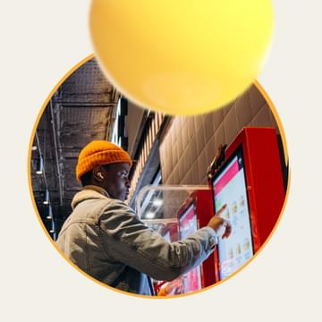Person picking menu items on a kiosk screen
