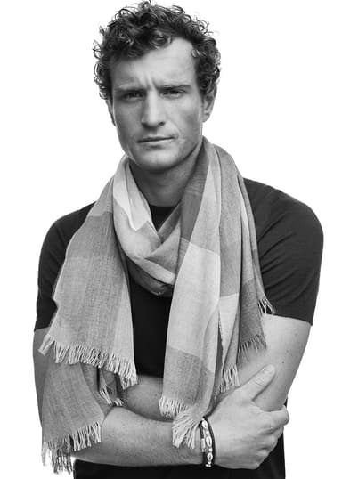 Model wearing a Johnstons of Elgin Lightweight Scarf around his neck shot in black and white