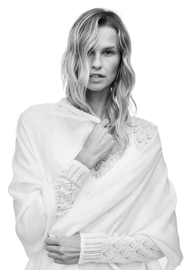 Model wearing a Johnstons of Elgin lightweight scarf wrapped around her shoulders shot in black and white