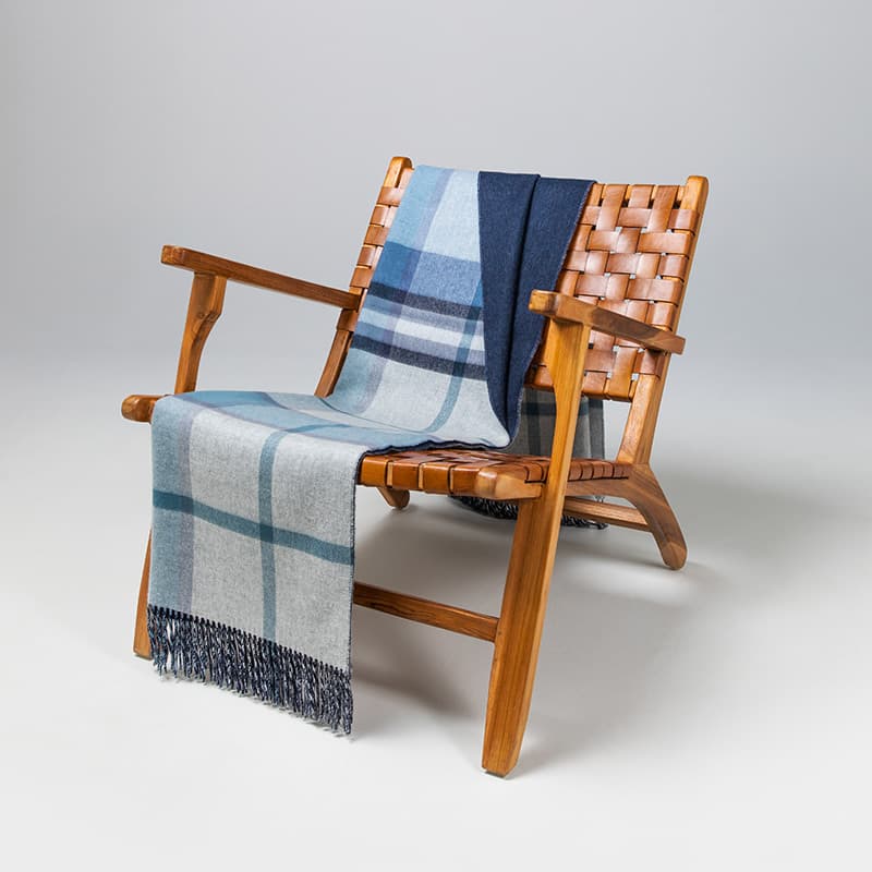 Johnstons of Elgin Spey Check Reversible Cashmere Throw on a wooden chair