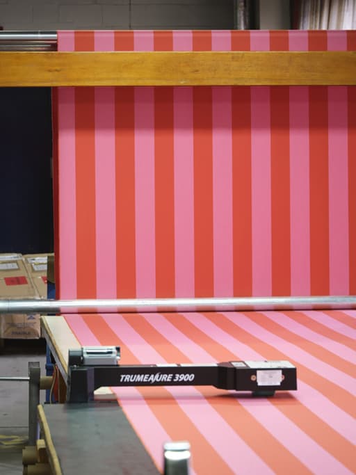 Ben Pentreath and Johnstons of Elgin's pink and red fabric drying in Elgin mill