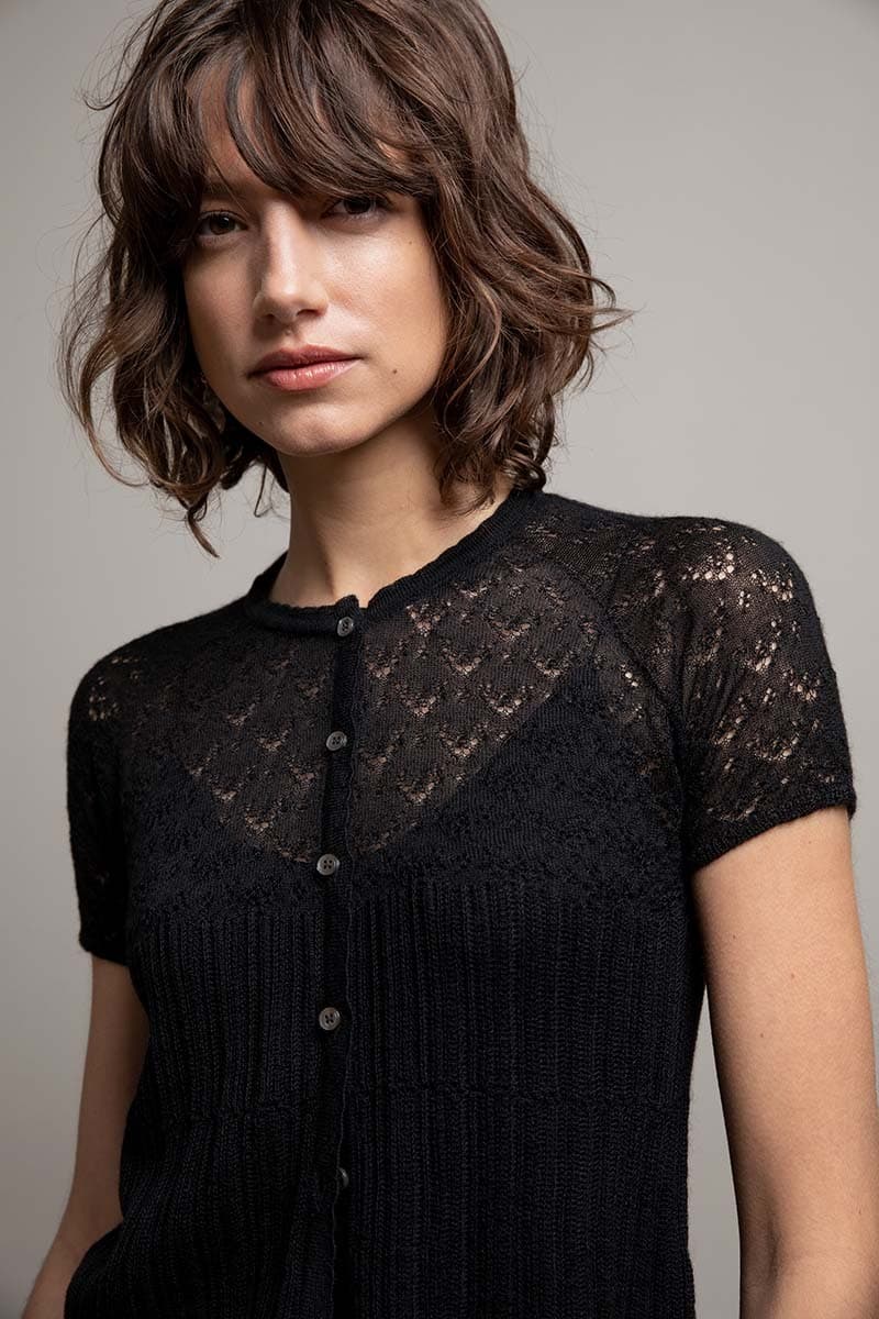 Johnstons of Elgin Women's Lace Stitch Black Cashmere Silk Cardigan worn over a black camisole