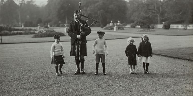 Lieutenant General Sir George Gordon Lennox (far left) as a child wearing his kilt pictured with Piper MacKenzie in 1912