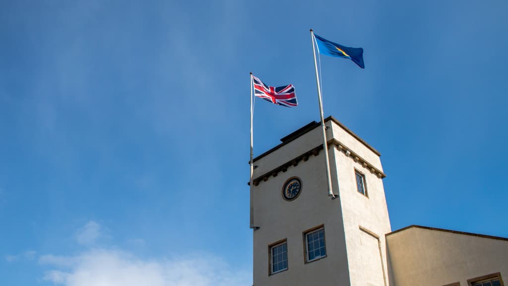Johnstons of Elgin Clock Tower with the Union Jack and Queen's Sustainability Award Flags Flying