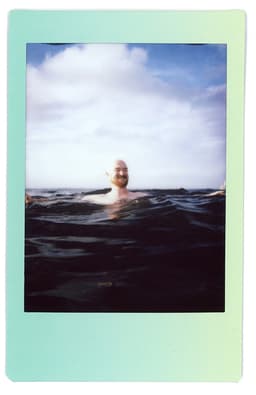 Johnstons of Elgin image of a man wild swimming in the sea off the Hopeman coast