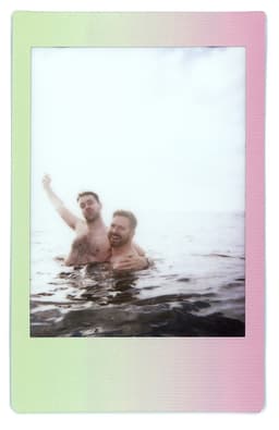 Johnstons of Elgin image of two men wild swimming in the sea off the Hopeman coast