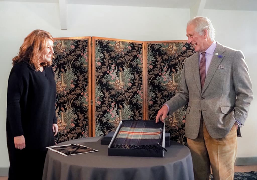 Johnstons of Elgin's Chairman Jenny Urquhart marked Wool Week in a socially distanced meeting with HRH The Duke of Rothesay, presenting him with an exclusive woollen blanket