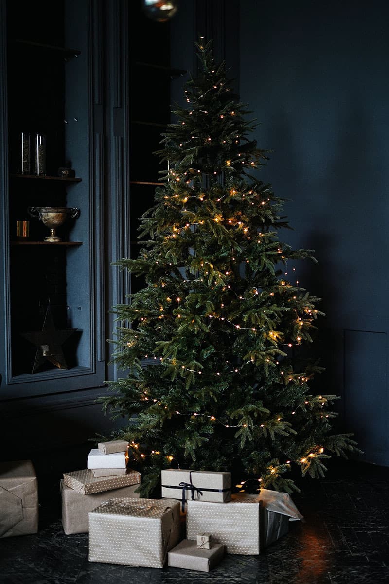 Christmas tree with silver parcels with navy walls