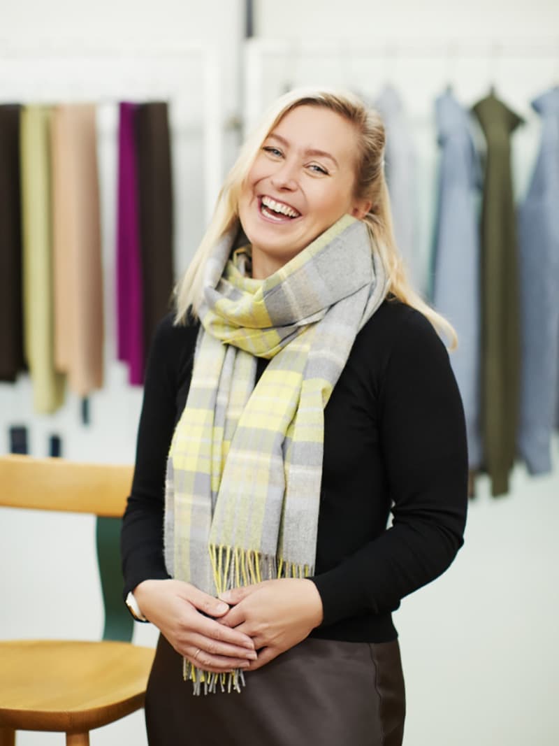 Our Design Director for Wovens, Laura Garner wearing a Japan Special Cashmere Stole in light taupes and greys and included a neon yellow highlight