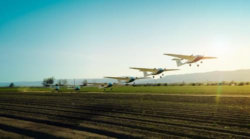 Pyka airplanes taking off in a field