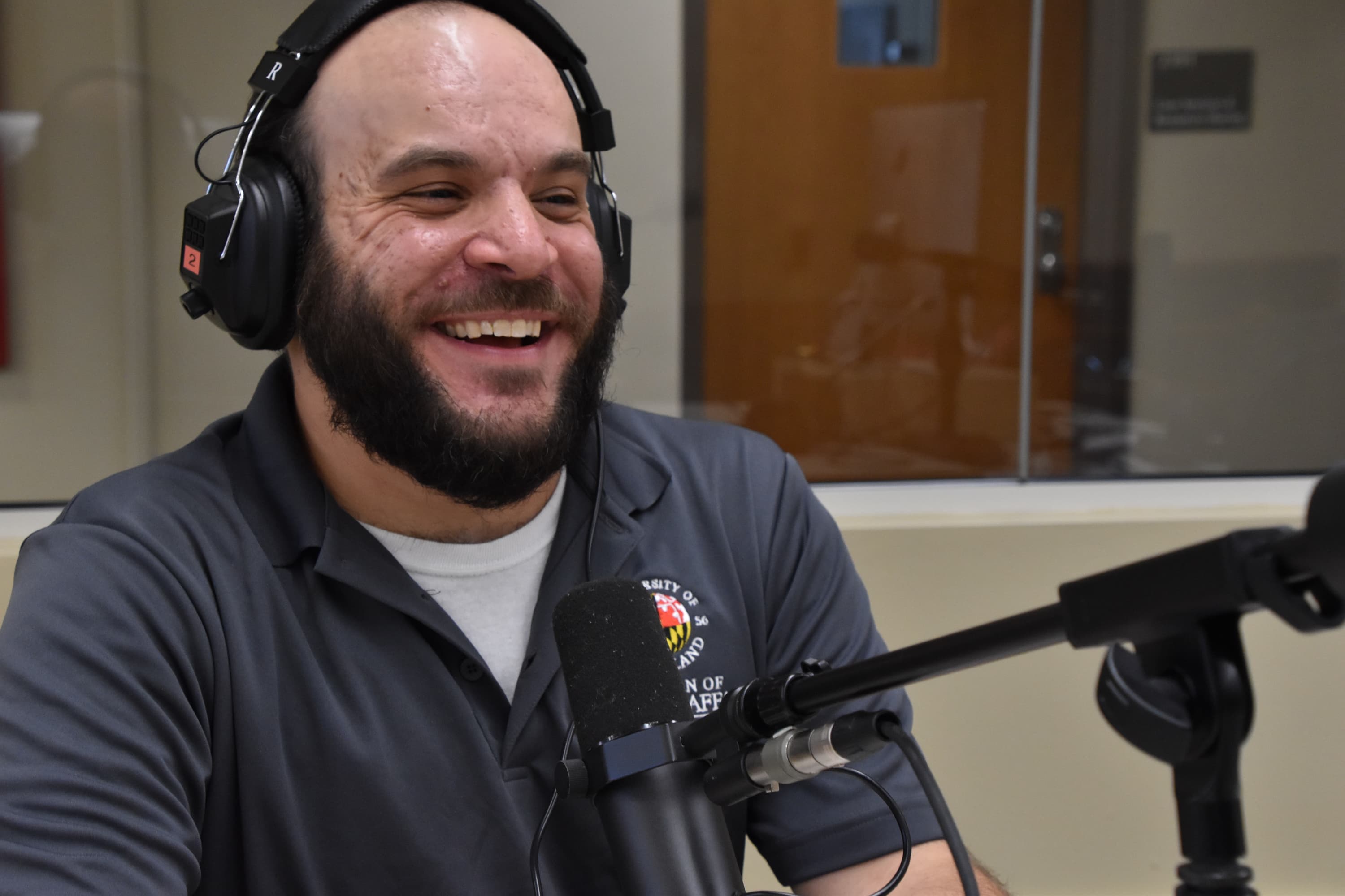 Ray Nardella laughing and sitting in front of a mic with headphones on