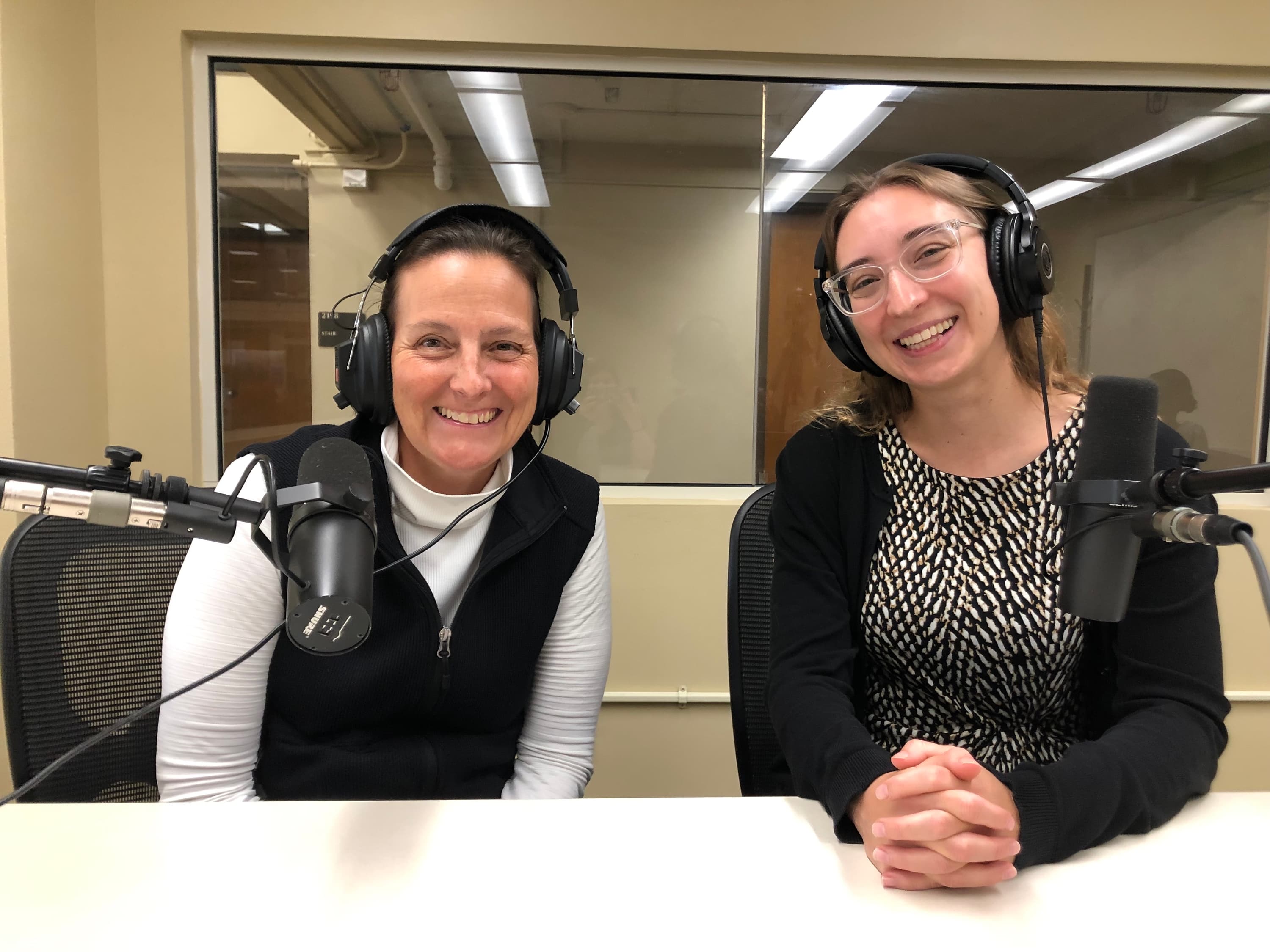 Kelsey Eustace and ADA coordinator Emily Singer Lucio smiling for a photo in the podcasting lab