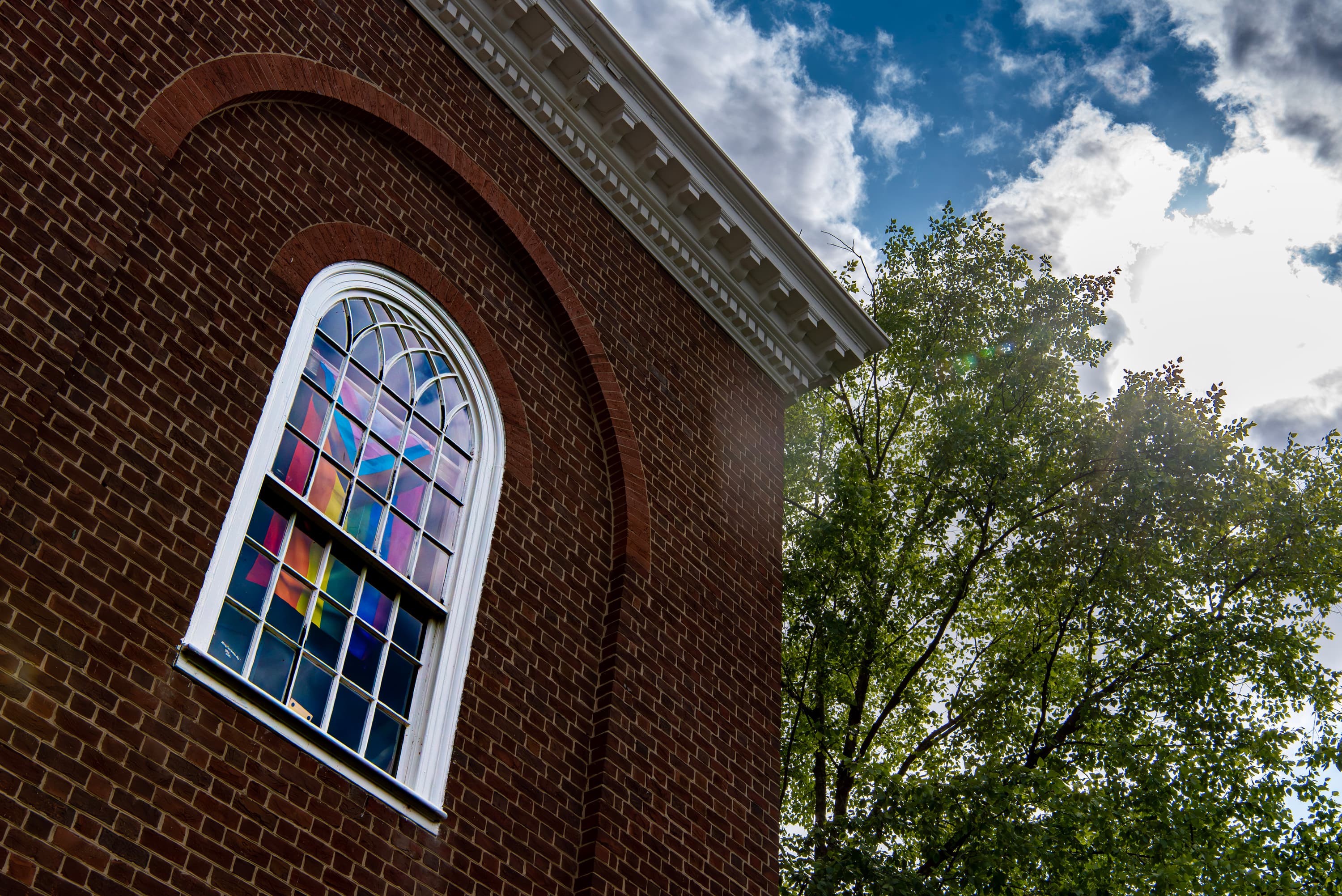 Photo of pride flag in the window of Memorial Chapel