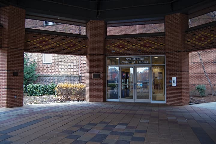 Back entrance to Nyumburu Cultural Center with laid bricked painted in a geomatic pattern along the upper walls.