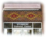 Nyumburu cultural center rear entrance with red, black, and gold bricks layered in a geometric pattern above the doors