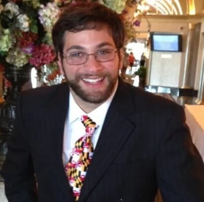 Aaron Kaufman smiles in a Maryland flag tie