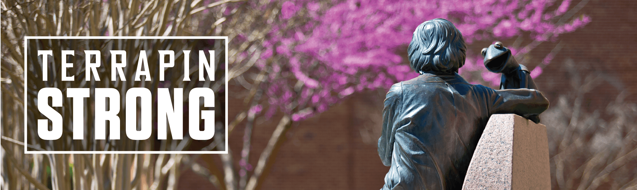 logo over image of Jim Henson statue