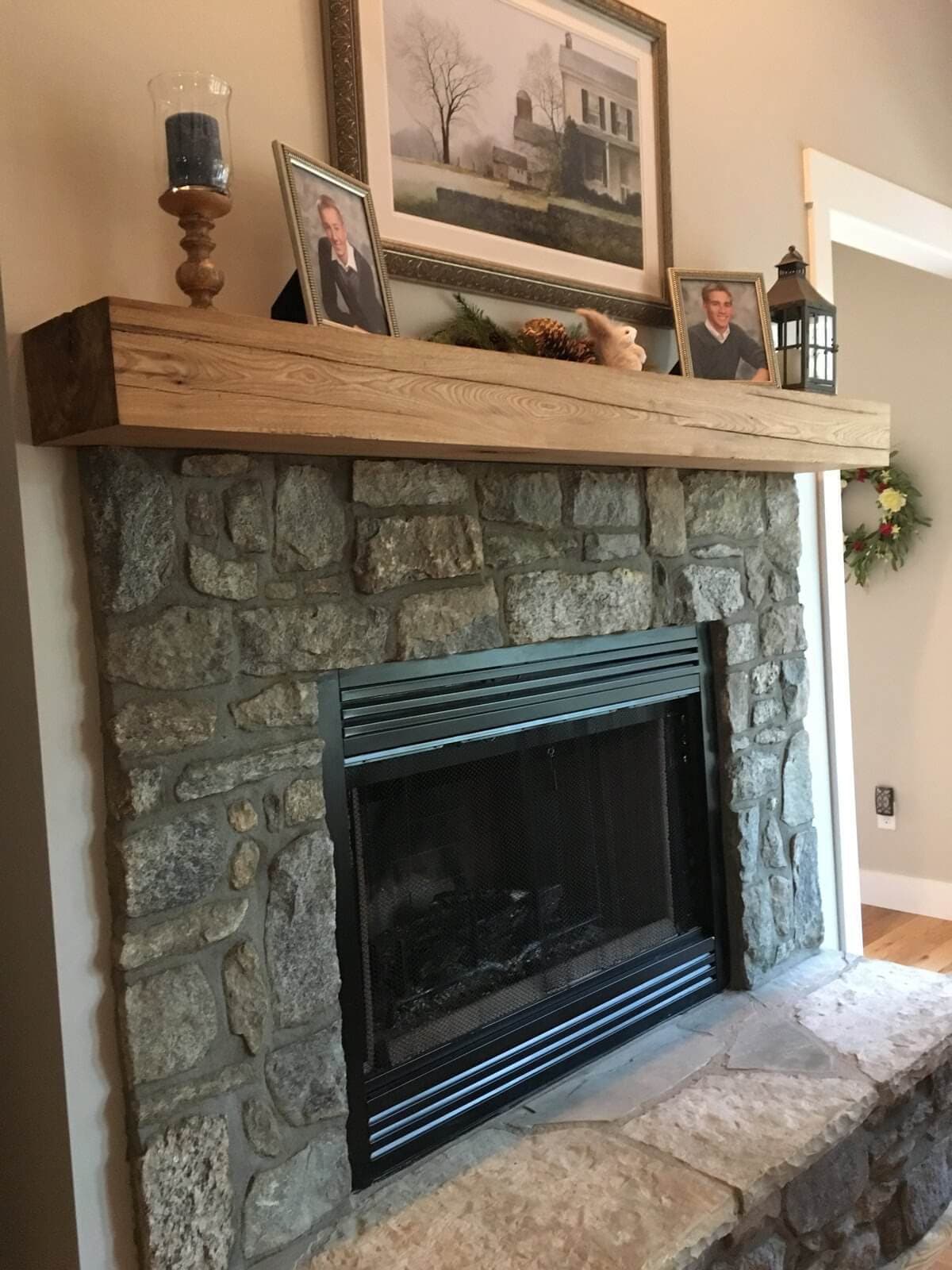 reclaimed ash mantel over a fireplace and under a picture