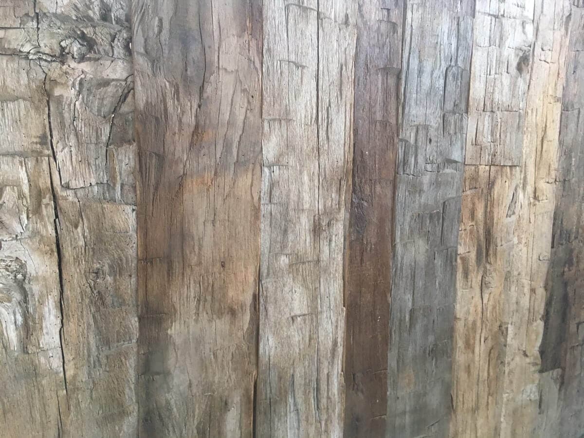 reclaimed accent wall of multi hued hand hewn skins