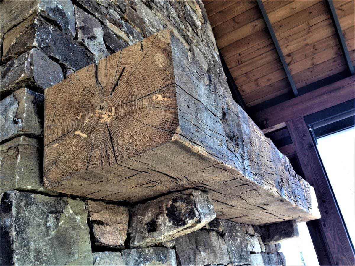 Hand hewn rustic fireplace mantel.