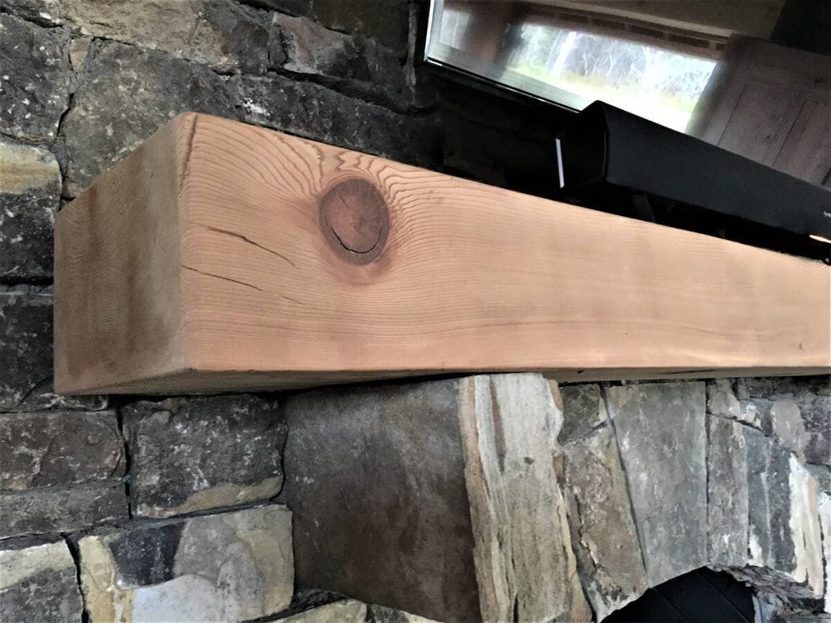 reclaimed smooth fir mantel over a fireplace and unfinished