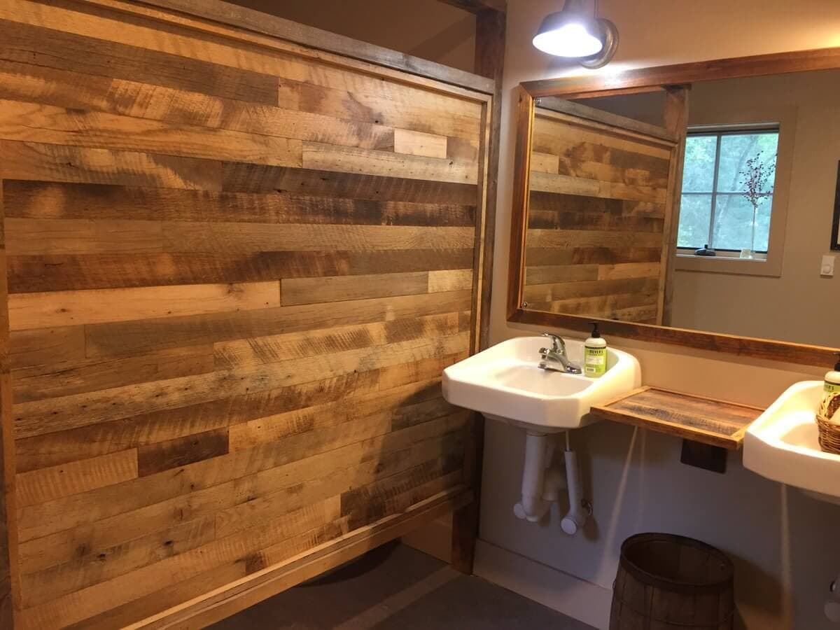 reclaimed hardwood bathroom divider next to sink and mirror