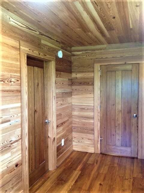 Antique heart pine wall cladding around 2 doors in NC