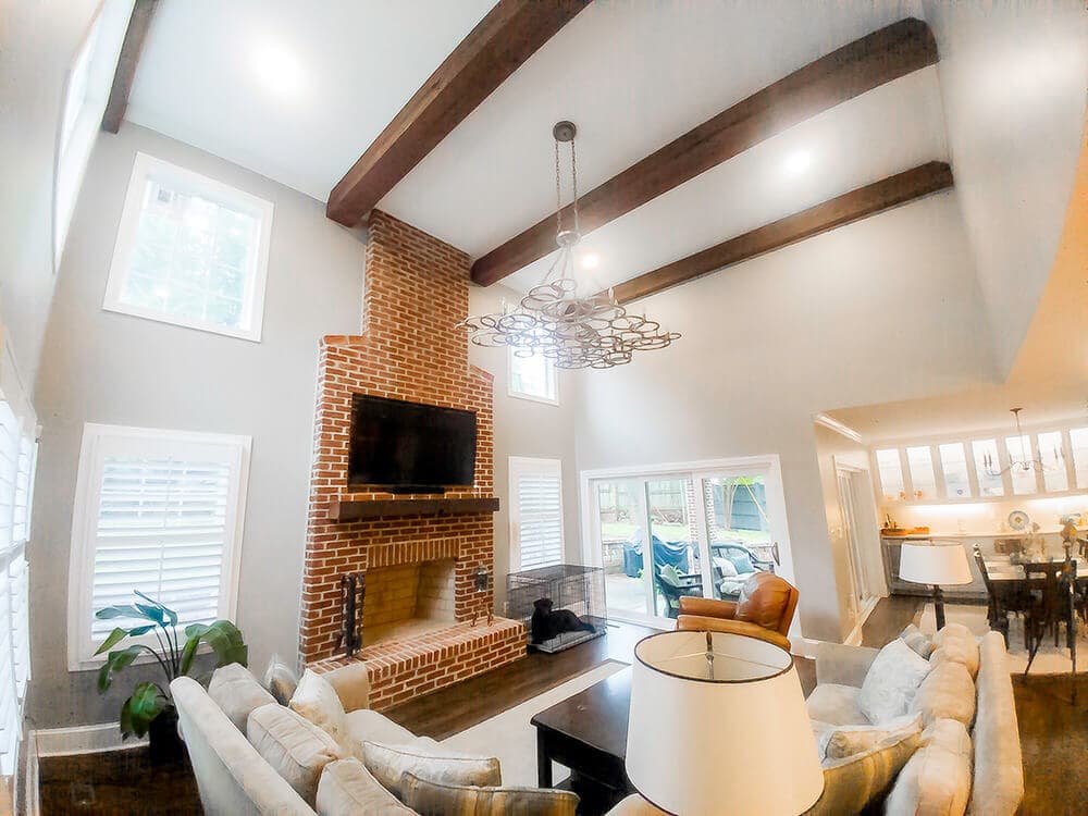 Reclaimed wood beams over fireplace in living room.