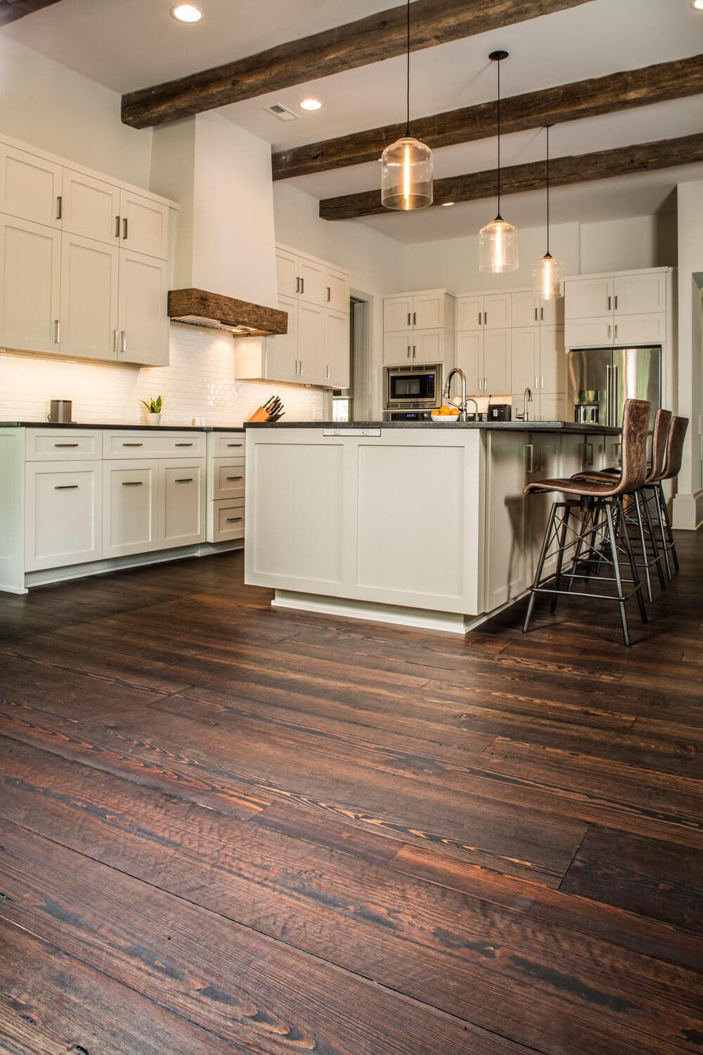 wide plank engineered floor and ceiling beams in a kitchen