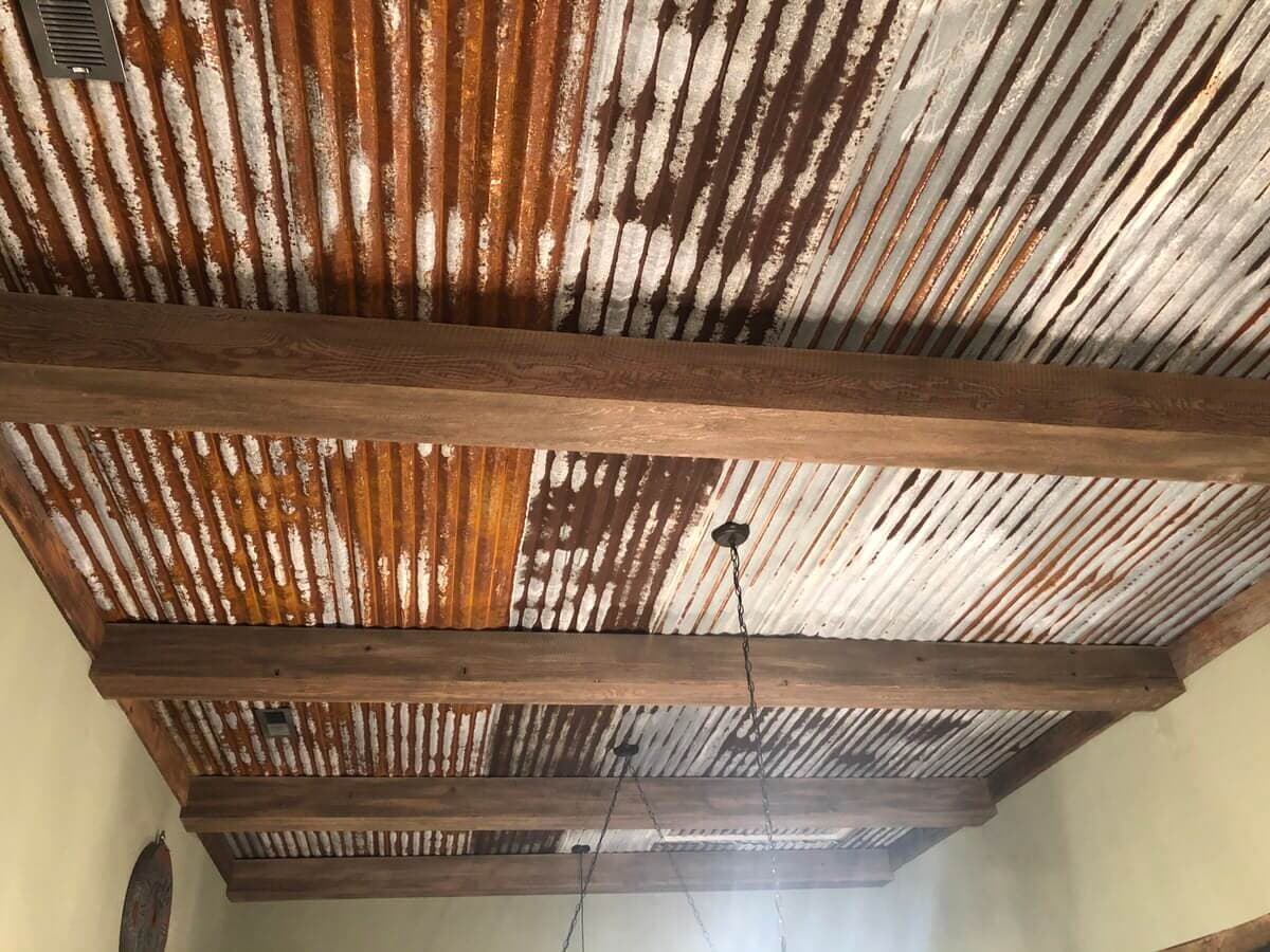 circle sawn reclaimed box beams and a reclaimed tin ceiling