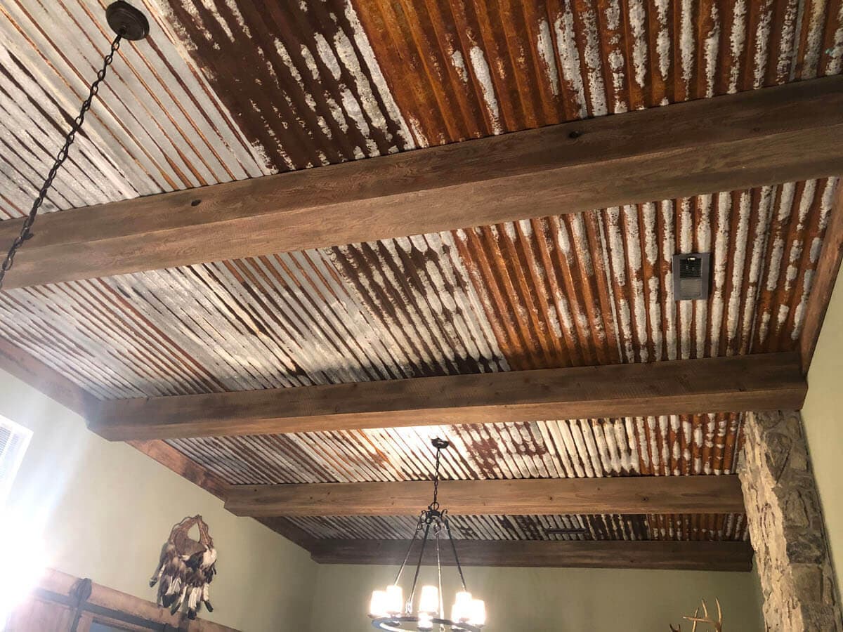 Circle sawn Doug Fir beam wraps and reclaimed tin ceiling