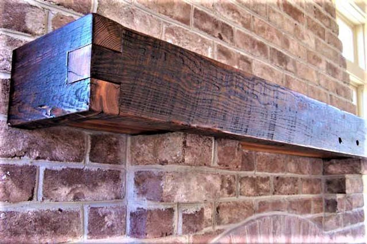 Stunning Craftman mantel made from heart pine featured finger joints on brick fireplace.