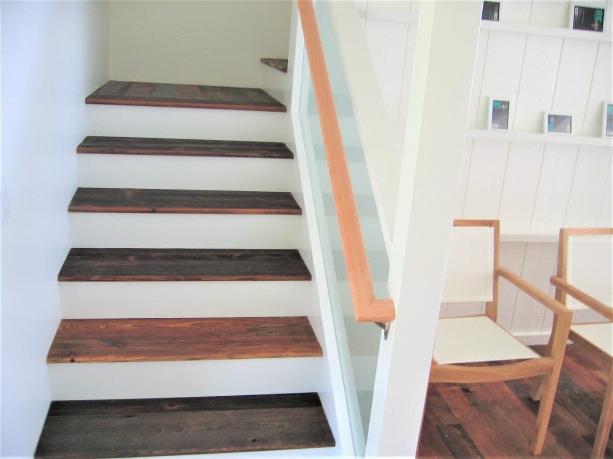 Heart pine stair treads on white wood risers and walls in hawaii
