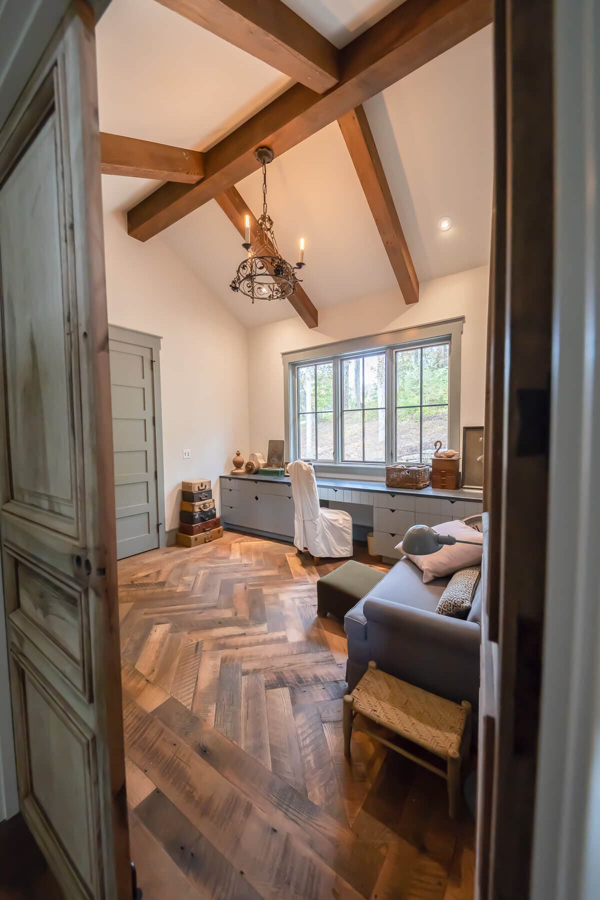 Patterned rustic reclaimed wood flooring in Grand Highlands living room.