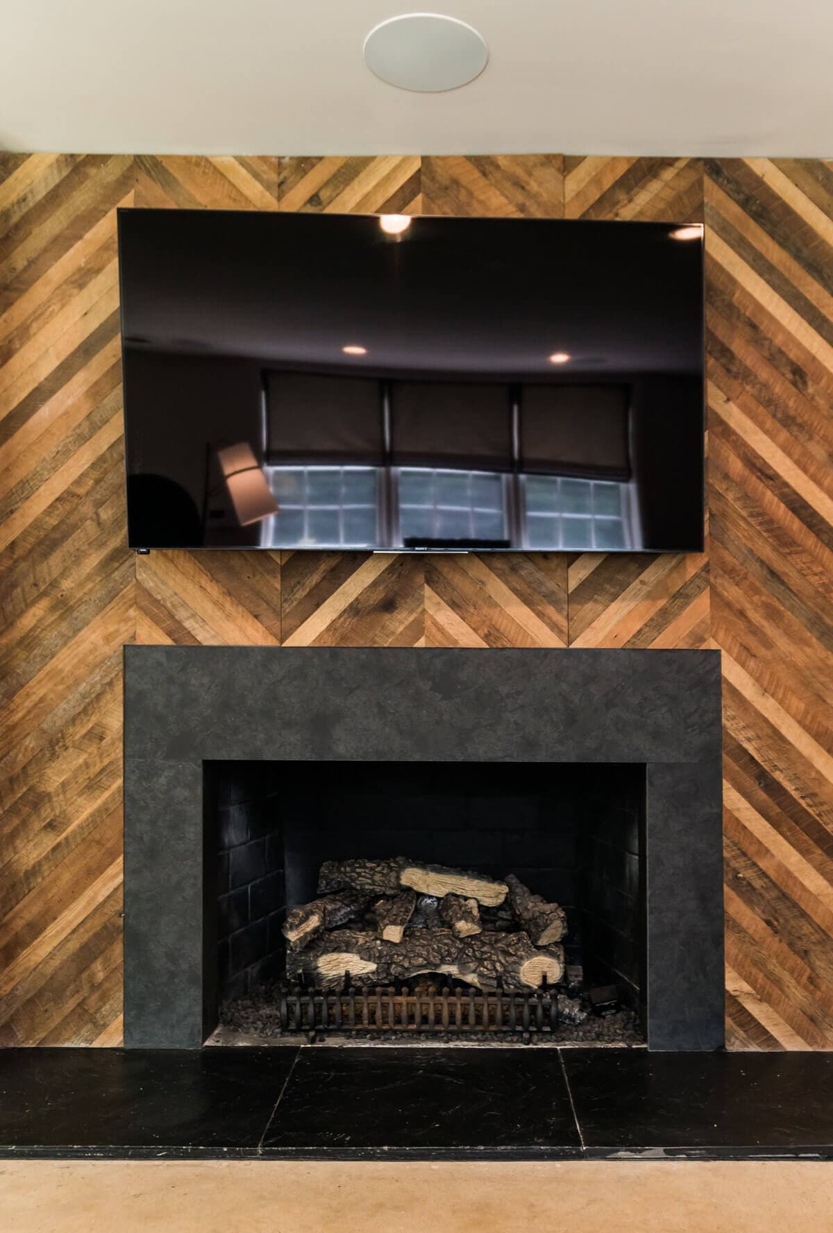 Reclaimed patterned accent wall panels around a fireplace in greenville, sc