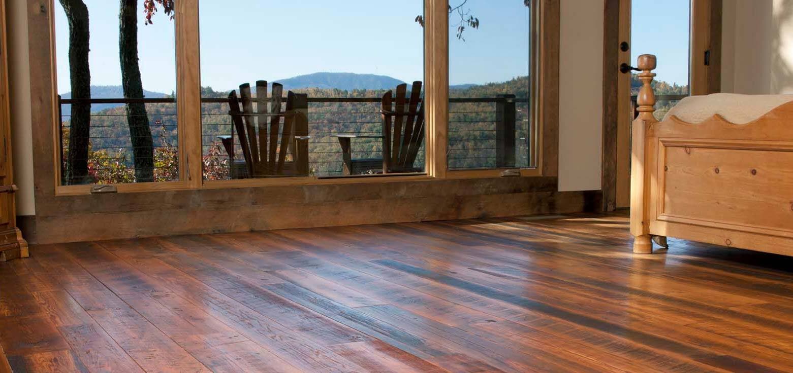 Reclaimed engineered wood flooring in bedroom.